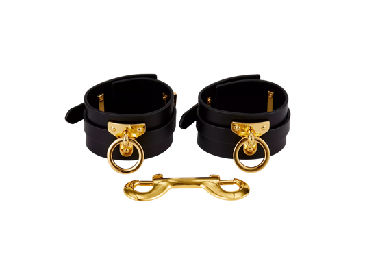 Black leather ankle cuffs with gold o rings 