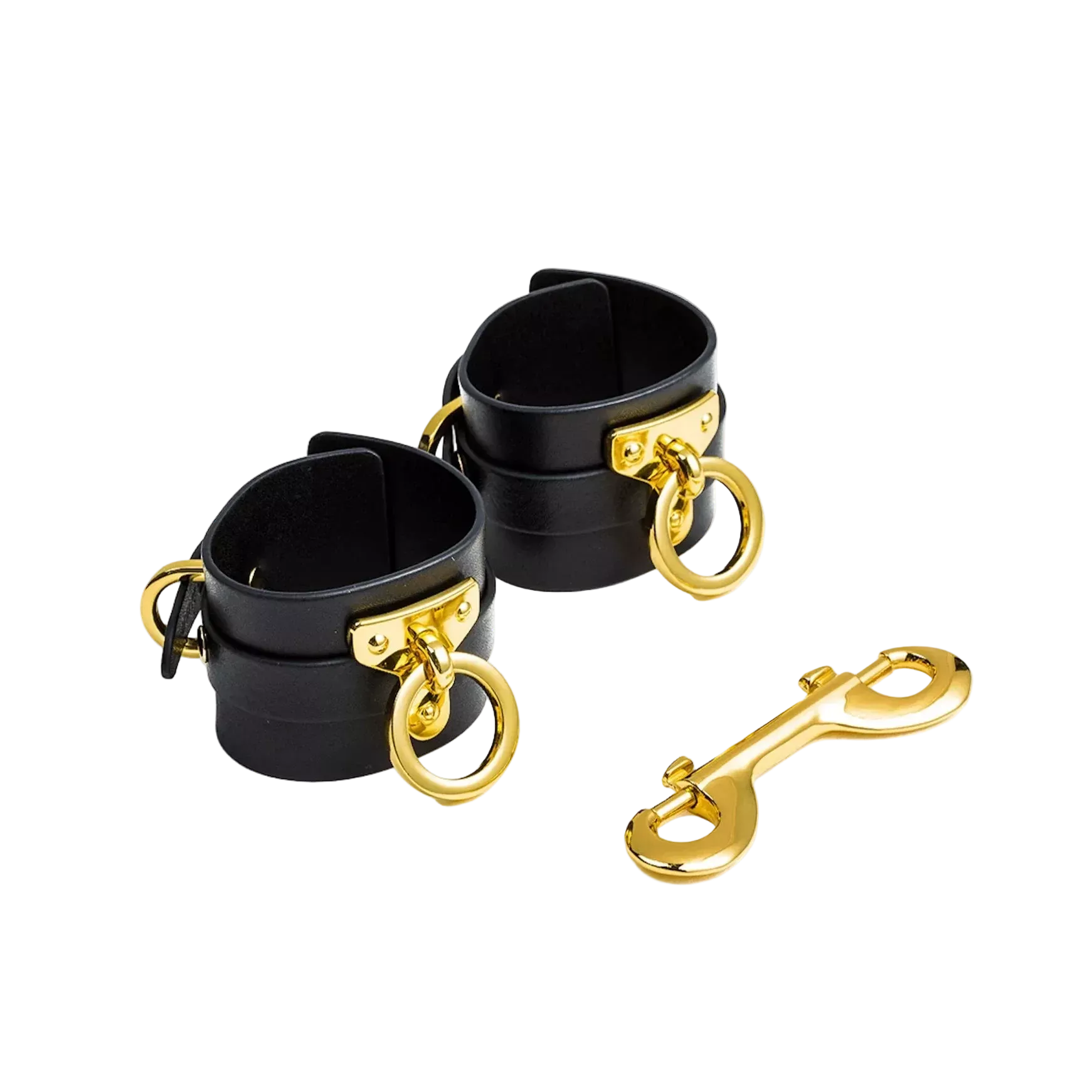 Black cuffs with gold hardware and a matching golden link clasp